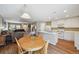 Open-concept layout with kitchen, dining area, and living room for easy entertainment at 5786 Biscay St, Denver, CO 80249