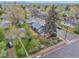 Aerial view of a charming home featuring a well-manicured yard, a lush garden and mature trees at 3201 S Clarkson St, Englewood, CO 80113
