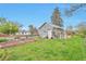 Lush backyard featuring garden boxes, mature trees, a tool shed, and a large grass lawn at 3201 S Clarkson St, Englewood, CO 80113