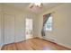 Cozy bedroom with a ceiling fan, closet and hardwood floors leading to an adjoining bathroom at 3201 S Clarkson St, Englewood, CO 80113