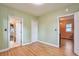 Sunlit bedroom with hardwood floors and white trim, showcasing multiple entryways at 3201 S Clarkson St, Englewood, CO 80113