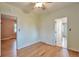 Bright bedroom featuring hardwood floors, ceiling fan, closet, and multiple doors to other rooms at 3201 S Clarkson St, Englewood, CO 80113