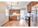 Modern kitchen featuring stainless steel appliances and wood cabinets at 3201 S Clarkson St, Englewood, CO 80113