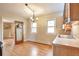 Bright kitchen with wood cabinets, hardwood floors, stainless sink and vintage light fixture at 3201 S Clarkson St, Englewood, CO 80113