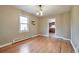 Hardwood floors, ample natural light, with an open doorway to the kitchen at 3201 S Clarkson St, Englewood, CO 80113