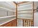 Well-organized pantry with wooden shelves, wine rack, and ample storage space at 3201 S Clarkson St, Englewood, CO 80113