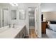 Bright bathroom featuring a spacious vanity, framed mirrors and a glass enclosed shower at 7272 E Appleton Cir, Centennial, CO 80112