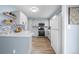 Bright kitchen with stainless steel appliances, white cabinets, and a stylish backsplash at 7272 E Appleton Cir, Centennial, CO 80112