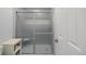 Cleanly designed walk in shower with frosted sliding glass door and tiled walls at 7272 E Appleton Cir, Centennial, CO 80112