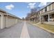 Neighborhood street scene with garages and townhomes, featuring a sidewalk and mature trees, offering a peaceful setting at 7272 E Appleton Cir, Centennial, CO 80112