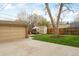 Landscaped backyard featuring a patio set and storage shed with grass and a concrete pad at 1055 S Clayton Way, Denver, CO 80209