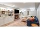 Finished basement featuring a brick fireplace, built-in shelving, and comfortable seating at 1055 S Clayton Way, Denver, CO 80209