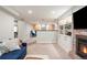 Finished basement featuring a brick fireplace, built-in shelving, and open layout at 1055 S Clayton Way, Denver, CO 80209