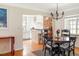 Charming dining area open to the kitchen, featuring a round table, hardwood floors, and ample natural light at 1055 S Clayton Way, Denver, CO 80209