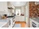 Beautiful, modern kitchen featuring white cabinets, marble countertops, stainless steel appliances, and hardwood floors at 1055 S Clayton Way, Denver, CO 80209