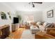 Bright living room with hardwood floors, comfortable seating, a cozy fireplace, and lots of natural light at 1055 S Clayton Way, Denver, CO 80209