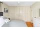 Bright main bedroom featuring built-in wardrobe and hardwood floors at 1055 S Clayton Way, Denver, CO 80209
