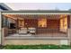 Covered patio with a brick wall, and wrought-iron railing providing an inviting outdoor living space at 1055 S Clayton Way, Denver, CO 80209