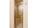 Enclosed shower featuring neutral tile, a glass door, and a built-in bench for added convenience at 1055 S Clayton Way, Denver, CO 80209