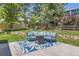 Inviting backyard patio with comfortable seating, a fire pit, and a play structure at 9929 W Fairview Ave, Littleton, CO 80127
