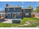 Back exterior of home with outdoor seating, patio, and a well-maintained lawn at 9929 W Fairview Ave, Littleton, CO 80127
