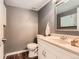 Charming powder room features a classic vanity, decorative mirror, and fresh decor at 9929 W Fairview Ave, Littleton, CO 80127
