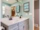 Updated bathroom featuring a double vanity and neutral color scheme at 9929 W Fairview Ave, Littleton, CO 80127