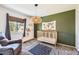 Adorable Bedroom featuring a woven light fixture, crib and earth-tone decor at 9929 W Fairview Ave, Littleton, CO 80127