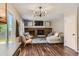 Inviting living room featuring a brick fireplace, hardwood floors, modern lighting, and comfortable seating at 9929 W Fairview Ave, Littleton, CO 80127