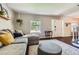 Cozy living room with a large window, plush seating and an area rug welcomes you inside at 9929 W Fairview Ave, Littleton, CO 80127