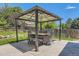 Outdoor dining area with seating for six and a pergola covered with lights at 9929 W Fairview Ave, Littleton, CO 80127