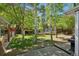 Spacious backyard includes a playhouse, swing set, trampoline, and mature trees for shade at 2865 Newland St, Wheat Ridge, CO 80214
