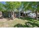 Backyard featuring mature trees, lush lawn, grill, a small deck, and a stone pathway at 2865 Newland St, Wheat Ridge, CO 80214