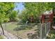 Fenced backyard featuring a playhouse, swing set, and plenty of room for outdoor play at 2865 Newland St, Wheat Ridge, CO 80214