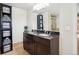 Bathroom featuring a double vanity with granite countertops and a view of the shower at 2865 Newland St, Wheat Ridge, CO 80214