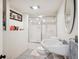 Basement bathroom with a shower featuring a decorative glass door at 2865 Newland St, Wheat Ridge, CO 80214
