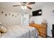 Comfortable bedroom featuring a ceiling fan, warm colors, and charming nautical decor at 2865 Newland St, Wheat Ridge, CO 80214