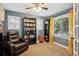Comfortable bedroom featuring a plush recliner, a bookcase, and carpet flooring at 2865 Newland St, Wheat Ridge, CO 80214