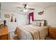 Cozy bedroom featuring a ceiling fan, warm colors, and a comfortable-looking bed at 2865 Newland St, Wheat Ridge, CO 80214