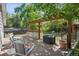 Entertain on the back deck with pergola, stylish bar, and seating with views of the fenced yard at 2865 Newland St, Wheat Ridge, CO 80214