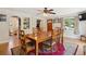 Inviting dining room with wood floors, a ceiling fan, and an arched doorway at 2865 Newland St, Wheat Ridge, CO 80214