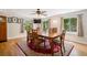 Cozy dining area with a ceiling fan, three windows, and a large, decorative rug at 2865 Newland St, Wheat Ridge, CO 80214