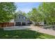 Lovely home with a large driveway, a two-car garage, and mature trees in the front yard at 2865 Newland St, Wheat Ridge, CO 80214