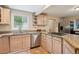 Kitchen features stainless steel appliances, light wood cabinets, granite countertops, and tiled backsplash at 2865 Newland St, Wheat Ridge, CO 80214