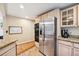 Spacious kitchen area featuring stainless steel refrigerator, oven, and beautiful light wood flooring at 2865 Newland St, Wheat Ridge, CO 80214