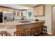 Kitchen with stainless steel appliances, light wood cabinets, granite countertops, and breakfast bar with stools at 2865 Newland St, Wheat Ridge, CO 80214