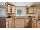 Charming kitchen featuring granite countertops, stainless steel appliances, and natural wood cabinets at 2865 Newland St, Wheat Ridge, CO 80214