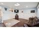 Inviting living room with a TV, a Gathering photo, and comfortable leather couches at 2865 Newland St, Wheat Ridge, CO 80214