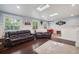 Spacious living room with hardwood floors, comfortable seating, and two skylights at 2865 Newland St, Wheat Ridge, CO 80214
