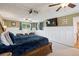 Spacious main bedroom with a large TV and a lot of natural light from the windows at 2865 Newland St, Wheat Ridge, CO 80214
